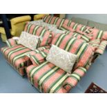 A three seater sofa, raised on castors and two single armchairs, in striped upholstery and raised on