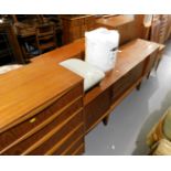 A six drawer chest of drawers, a small stool, duvet, and a sideboard of three drawers flanked by a s