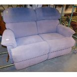 A La-Z-Boy two seater sofa, upholstered in light purple fabric, with reclining action.
