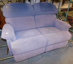 A La-Z-Boy two seater sofa, upholstered in light purple fabric, with reclining action.