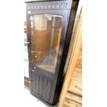 A linen fold dark oak display cabinet, with single glazed door over single panel door. Lots 1501 to