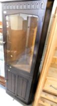 A linen fold dark oak display cabinet, with single glazed door over single panel door. Lots 1501 to