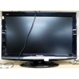 A Panasonic wide screen TV, with a 26" screen, model number TX-L26X10B.