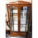 A display cabinet, with mirrored back, glazing to sides and to front doors over single drawer. Lots