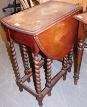 A small oak gate leg table, raised on barley twist supports.