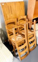 A dining table and four dining chairs, with rush seats. Lots 1501 to 1590 are available to view and