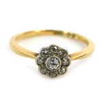 An 18ct gold diamond dress ring, the central floral cluster set with tiny diamonds, in rub over plat