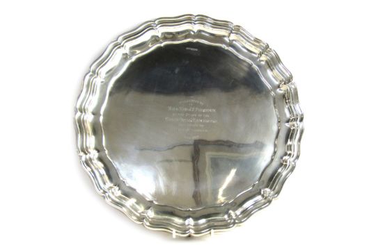 A George V silver salver, of circular form with piecrust border, raised on three scroll cast feet, - Image 1 of 4