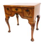 A George I style walnut lowboy, with boxwood strung top, above arrangement of one short and two long