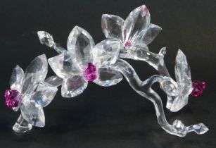 A Swarovski crystal floral display, depicting four flowers with pink coloured glass centres, on styl