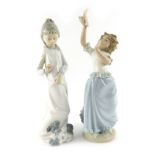 Two Nao porcelain figures, modelled as a young girl with dog, and a young girl holding dove, painted
