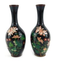 A pair of Japanese cloisonne vases, of cylindrical form with elongated neck, decorated with other fl