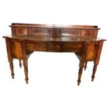 A George IV mahogany sideboard, the raised back with a gallery, above two sliding figured doors, the