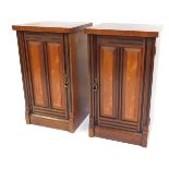 A pair of late 20thC mahogany pot cupboards, each with a moulded and banded door, with ebonised deta