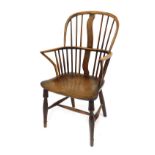A late 19thC ash and elm Windsor chair, with spindle back, replacement splat, the solid seat raised