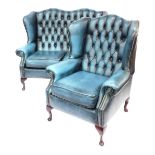 A Saxon button back wingback two seater sofa, with stud work, raised on four cabriole legs, with pad