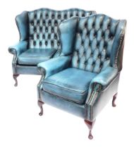 A Saxon button back wingback two seater sofa, with stud work, raised on four cabriole legs, with pad