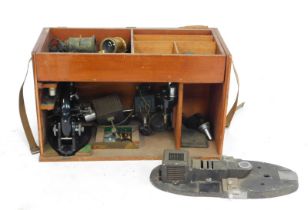 A fitted hardwood box containing a microscope by C Baker of London, model number 0877, with various