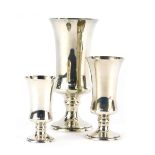 An Elizabeth II graduated set of three silver goblets, each of cylindrical waisted form, on circular