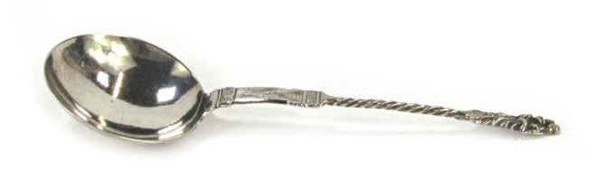 A Continental white metal serving spoon, with circular plain bowl, twisted stem and cast Virgin Mary