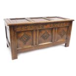An 18thC oak coffer, with three panelled top above three panelled carved sections, terminating