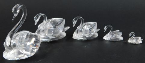 A set of four graduated Swarovski crystal swans, the largest 5.5cm high, together with a further cut