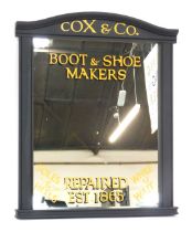 A 20thC painted mirror, bearing advertising script for Cox & Co Boot & Shoe Makers, 92cm x 74cm.