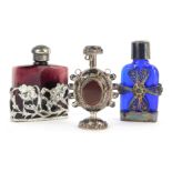 A 20thC blue glass and silver mounted scent bottle, with floral filigree decoration to the body, mar