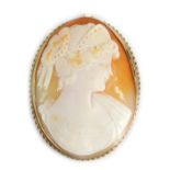 A 19thC shell cameo brooch, depicting maiden facing dexter, in a rub over setting with rope twist bo