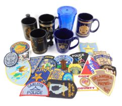 A group of Police related collectables, to include American Police cloth badges, West Burlington Iow