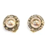 A pair of Georg Jensen silver clip on earrings, each with a waved outer border and central dome, sta