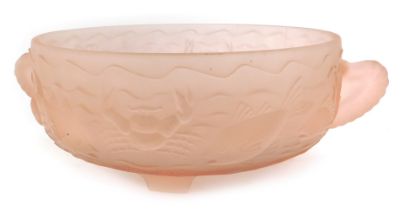 A pink frosted glass two handled bowl, relief moulded with fish, crustaceans, etc, on four tapering