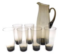 A mid century smoked glass lemonade set, comprising jug, 30cm high, and six glasses, 14cm high.