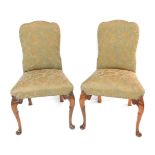 A pair of early 20thC George I style walnut single dining chairs, upholstered in gold floral fabric,