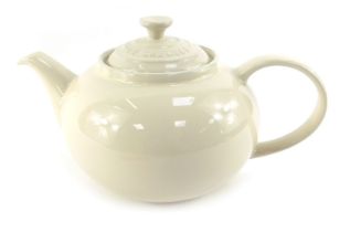 A Le Creuset pottery teapot, in cream, 12cm high.