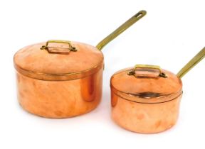 Two copper saucepans, each with a lid with brass handles, 21cm diameter, and 15cm diameter respectiv