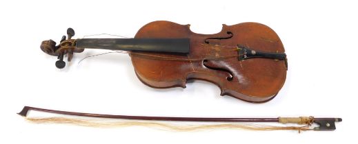 A 20thC violin and bow, by family repute from the Shetland Islands, violin 55cm long.