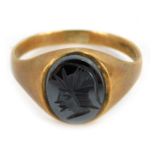 A 9ct gold signet ring, the oval cabachon set with black moon finish stone, engraved with a Centuria