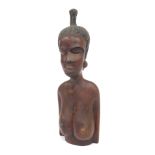 An African hardwood carving, depicting head, shoulders and torso of a female, 51cm high.