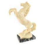A 20thC resin model of a rearing horse, signed A. Santini, on a veined marbled base, 29cm high.