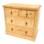 A stripped pine chest, of two short and two long drawers, with brass floral drop handles on block ba
