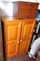 A pine two door cabinet, 101cm high, 72cm wide, 40cm deep, together with a wooden box. (2)