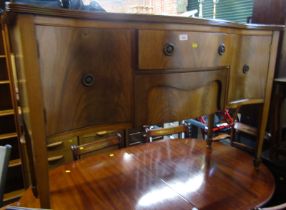 A mahogany serpentine fronted sideboard in George III style, the top with a moulded edge, the base w