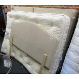 A double bed, comprising head board, divan base, mattress and mattress topper.