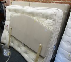 A double bed, comprising head board, divan base, mattress and mattress topper.