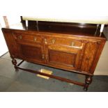 An early 20thC oak sideboard, the top with a raised back, the base with two drawers above two cupboa