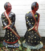 A pair of composition garden statues, modelled as Oriental gentleman holding swords, 73cm high.