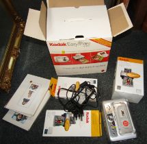 A Kodak Easy Share system digital camera, and printed dock.