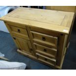 A pine side cabinet, with an arrangement of drawers and a cabinet, on plinth base, 84cm high, 92cm w