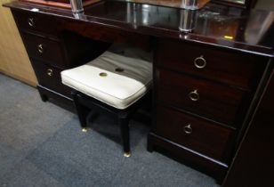 A Stag Minstrel mirror back dressing table, 134cm high, 137cm wide, 47cm deep, together with a foots